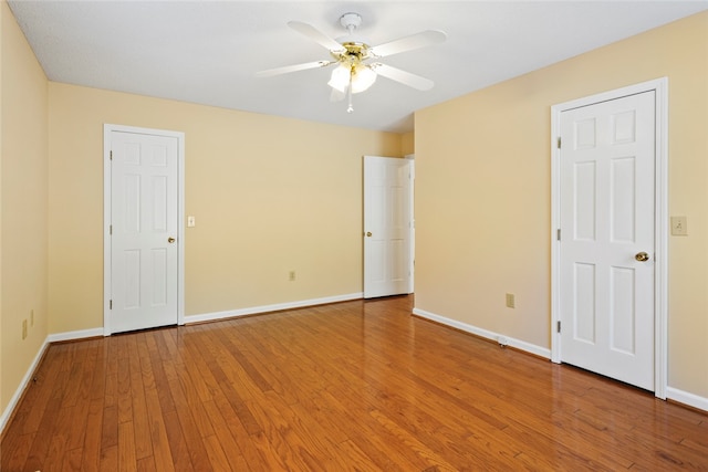 unfurnished bedroom with ceiling fan and wood-type flooring