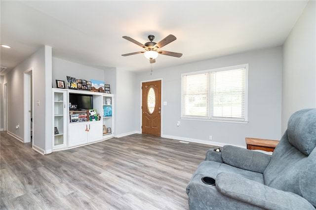 living room with wood-type flooring and ceiling fan