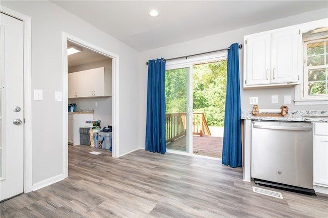 kitchen with light hardwood / wood-style floors, stainless steel dishwasher, and white cabinetry