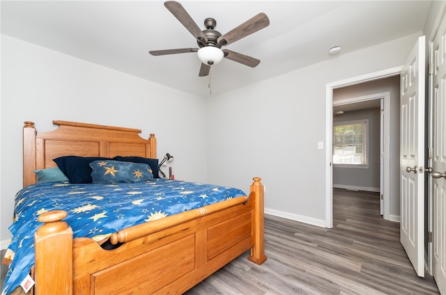 bedroom with ceiling fan and hardwood / wood-style flooring