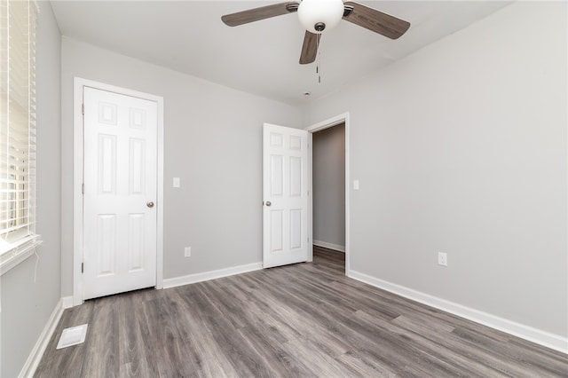 unfurnished bedroom with ceiling fan and hardwood / wood-style floors