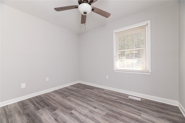 spare room with ceiling fan and dark hardwood / wood-style flooring