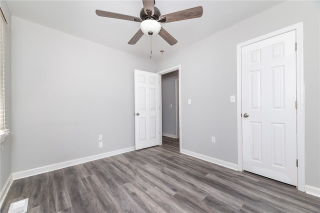 unfurnished bedroom with dark hardwood / wood-style flooring and ceiling fan