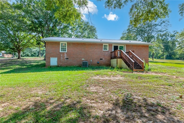 back of house featuring a lawn and cooling unit