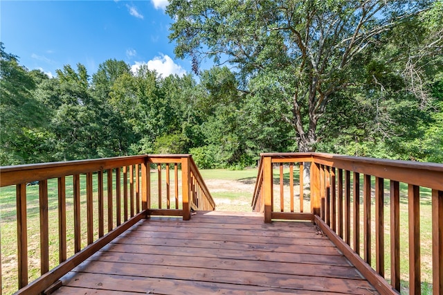 wooden deck with a lawn