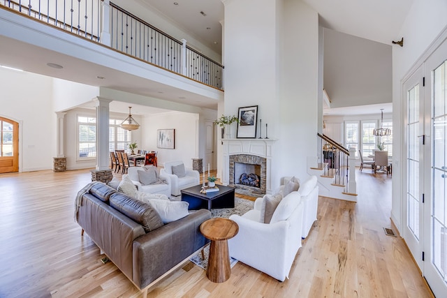 living room featuring high vaulted ceiling and a healthy amount of sunlight