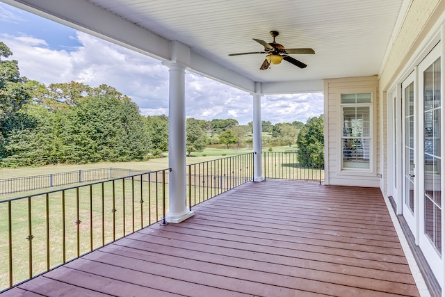 deck with ceiling fan and a yard