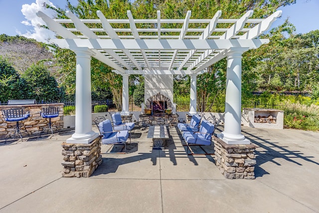 view of patio / terrace with an outdoor living space with a fireplace and a pergola