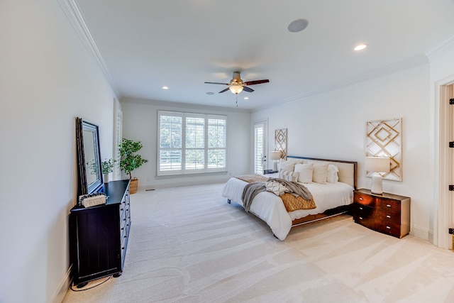 bedroom with ceiling fan, light carpet, and ornamental molding