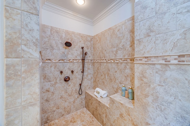 bathroom with ornamental molding and a tile shower