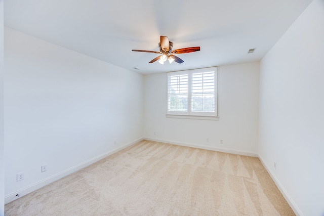 carpeted empty room featuring ceiling fan