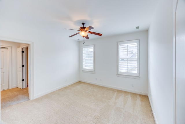 empty room with ceiling fan and light colored carpet