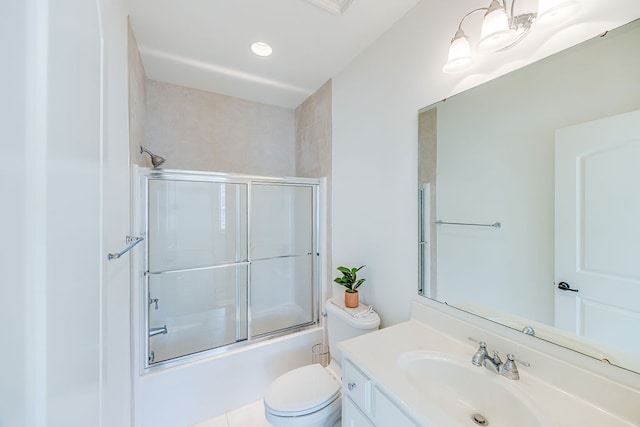 full bathroom featuring tile patterned floors, bath / shower combo with glass door, vanity, and toilet