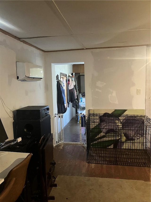 interior space with an AC wall unit and wood-type flooring