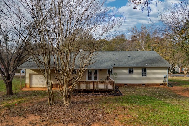 back of property with a deck, a garage, french doors, crawl space, and a lawn