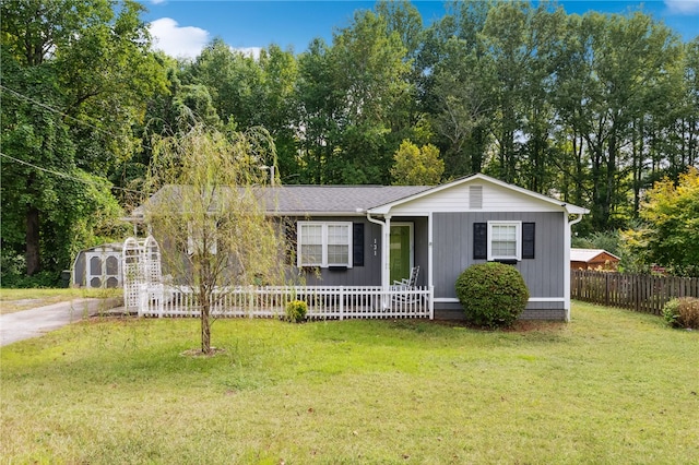 single story home with a front yard and a shed