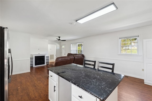 kitchen with stainless steel fridge, white cabinetry, dark hardwood / wood-style floors, and plenty of natural light