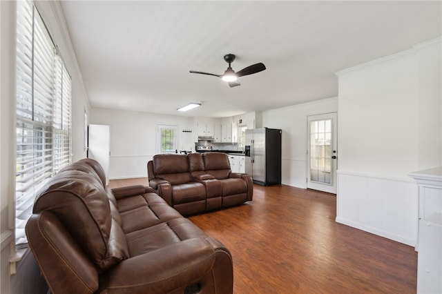 living room with dark hardwood / wood-style flooring and ceiling fan