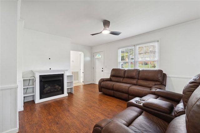 living room featuring ceiling fan and dark hardwood / wood-style flooring