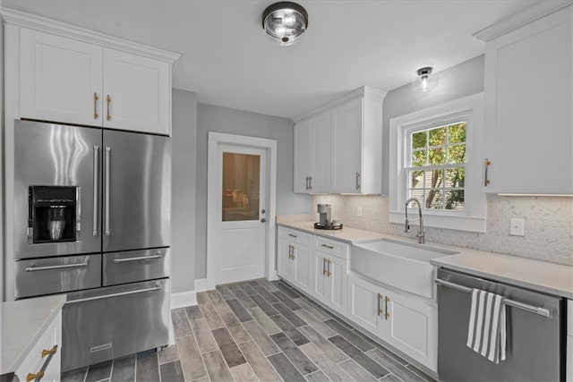 kitchen featuring white cabinetry, stainless steel appliances, dark wood-type flooring, and sink