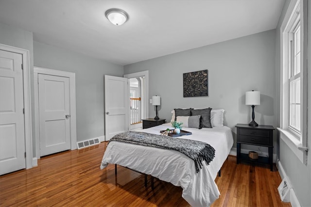 bedroom with hardwood / wood-style floors