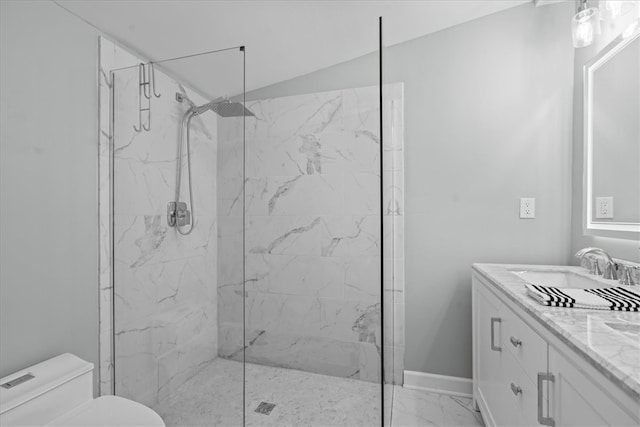 bathroom featuring vanity, toilet, and a shower with door