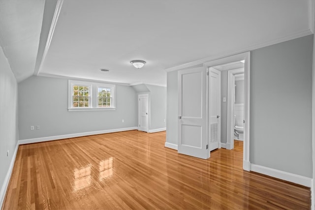 additional living space featuring lofted ceiling and hardwood / wood-style floors