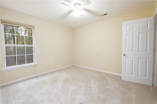 spare room featuring ceiling fan and light colored carpet