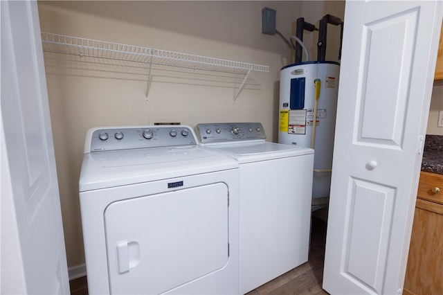 laundry area featuring water heater, dark hardwood / wood-style floors, and separate washer and dryer