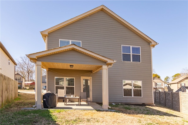 back of property with a patio