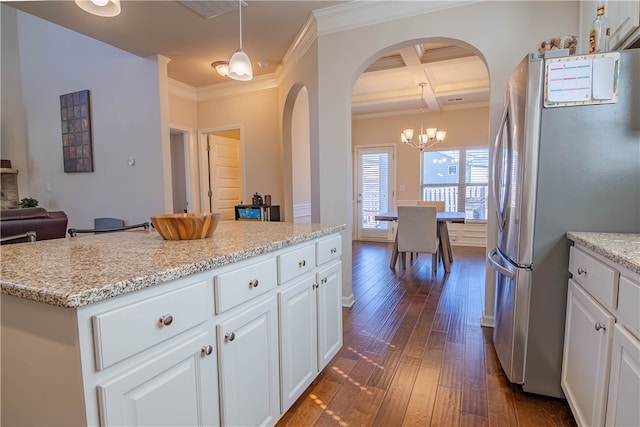 kitchen featuring coffered ceiling, hanging light fixtures, dark wood-type flooring, and white cabinetry