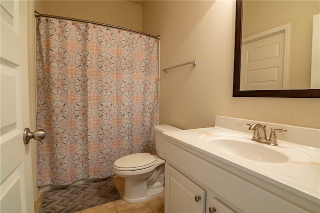 bathroom with curtained shower, vanity, toilet, and tile patterned floors