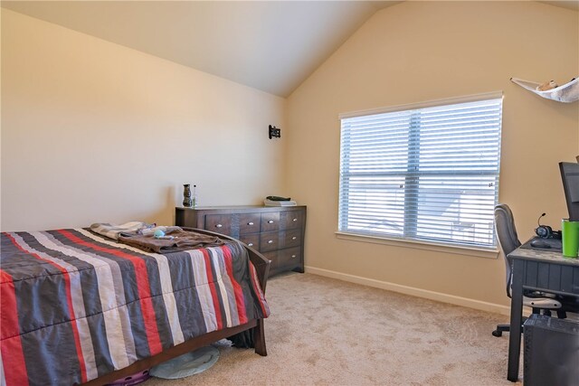 carpeted bedroom featuring vaulted ceiling