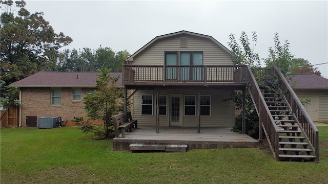 back of property with a lawn, cooling unit, and a deck