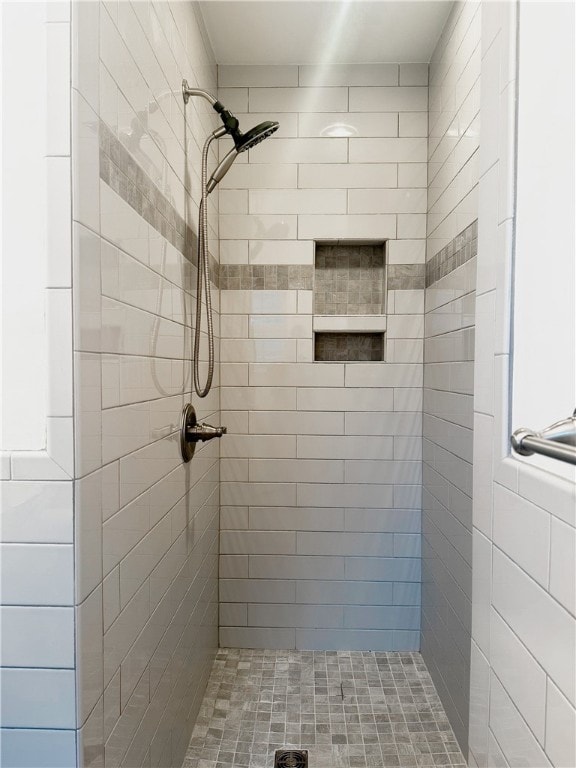 bathroom with tiled shower