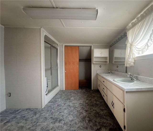 bathroom with an enclosed shower and vanity