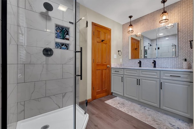 bathroom with walk in shower, vanity, decorative backsplash, and hardwood / wood-style flooring