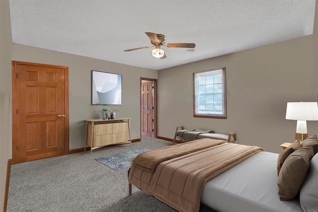 bedroom featuring ceiling fan, carpet floors, and a textured ceiling