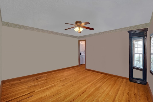 spare room featuring ceiling fan and light hardwood / wood-style flooring