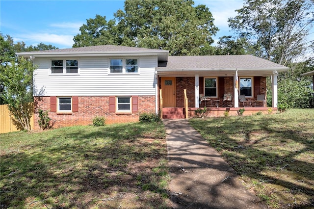 tri-level home featuring a front lawn and a porch