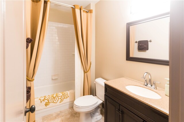 full bathroom featuring tile patterned floors, vanity, shower / tub combo with curtain, and toilet