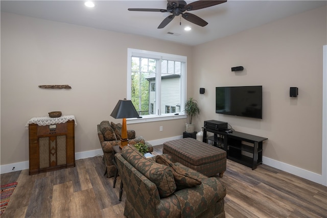 living room featuring dark hardwood / wood-style floors and ceiling fan