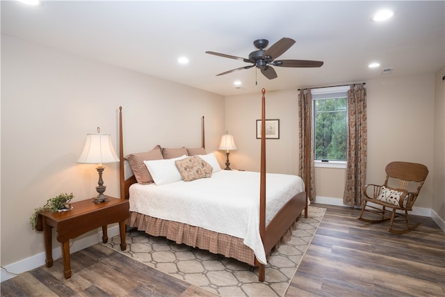 bedroom with ceiling fan and hardwood / wood-style flooring