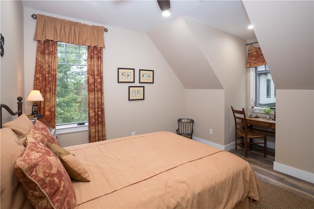 bedroom featuring ceiling fan, lofted ceiling, hardwood / wood-style floors, and multiple windows