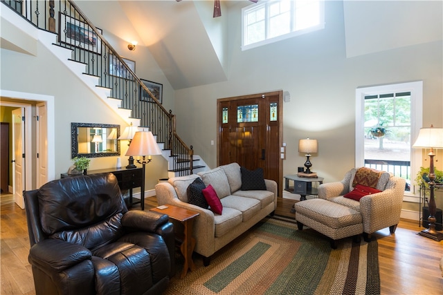 living room featuring light hardwood / wood-style floors and a high ceiling