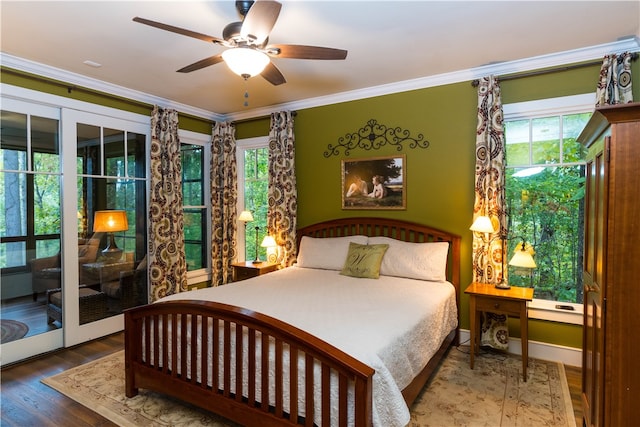 bedroom with multiple windows, ceiling fan, hardwood / wood-style floors, and crown molding