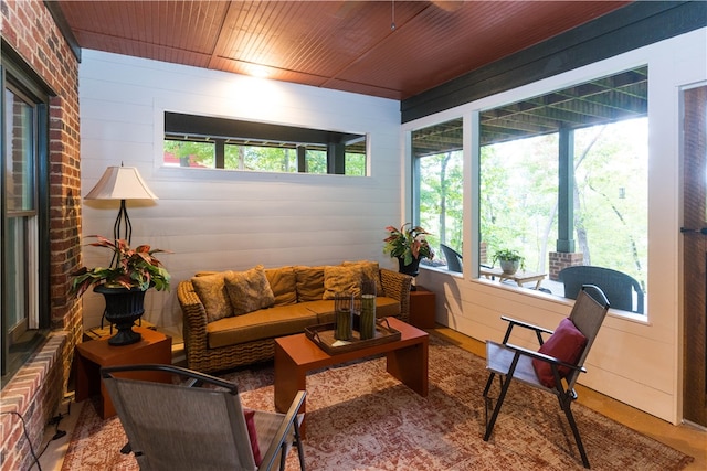 sunroom / solarium featuring plenty of natural light and wood ceiling