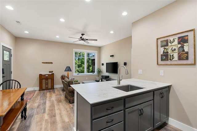 328 Grand Overlook Dr, Seneca, SC 29678 - kitchen featuring a sink, a peninsula, light stone countertops, light wood-style floors, and recessed lighting