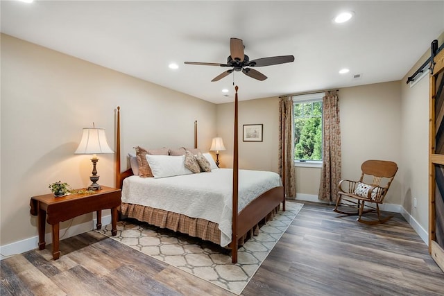 328 Grand Overlook Dr, Seneca, SC 29678 - bedroom featuring a barn door, recessed lighting, wood finished floors, and baseboards