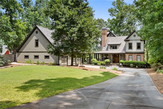 328 Grand Overlook Dr, Seneca, SC 29678 - view of front of house featuring a front lawn, a chimney, concrete driveway, and a porch